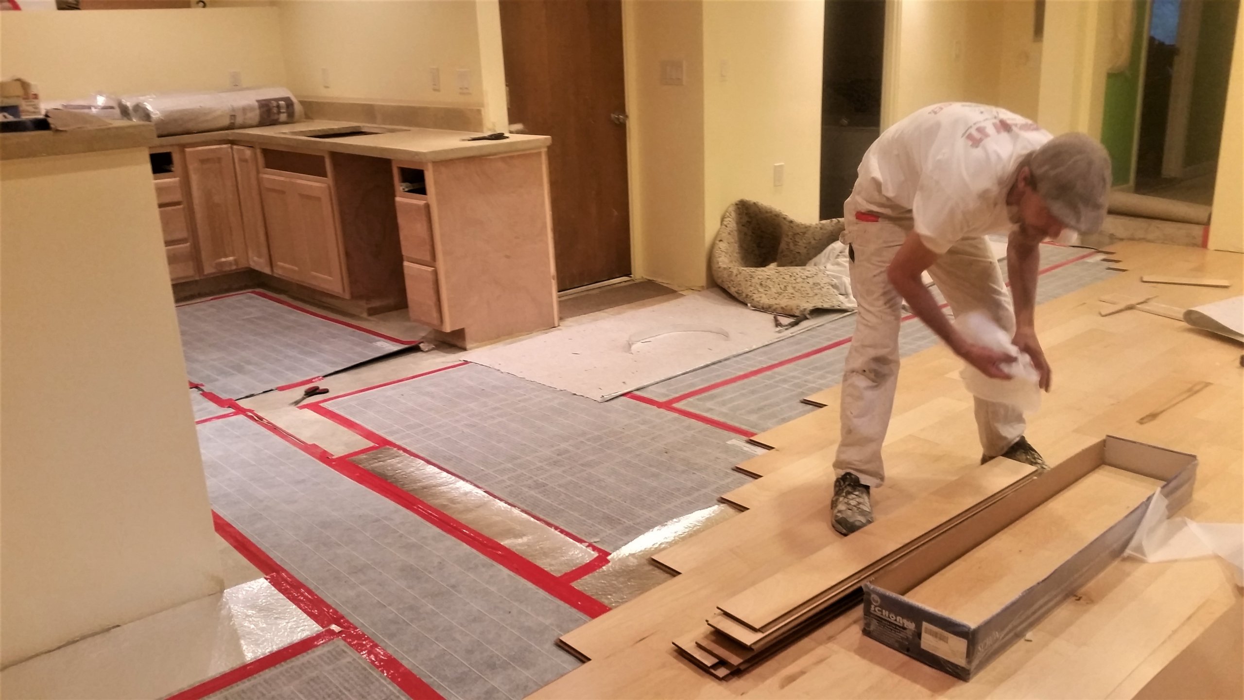 Basement flooring installation: laying down underlayment and flooring