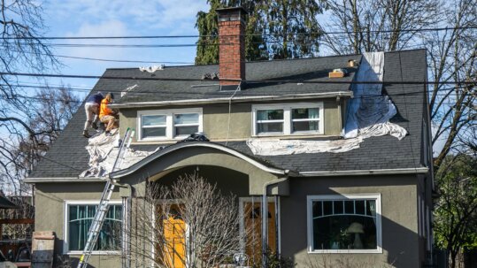 Roof repair: technician inspecting roof condition