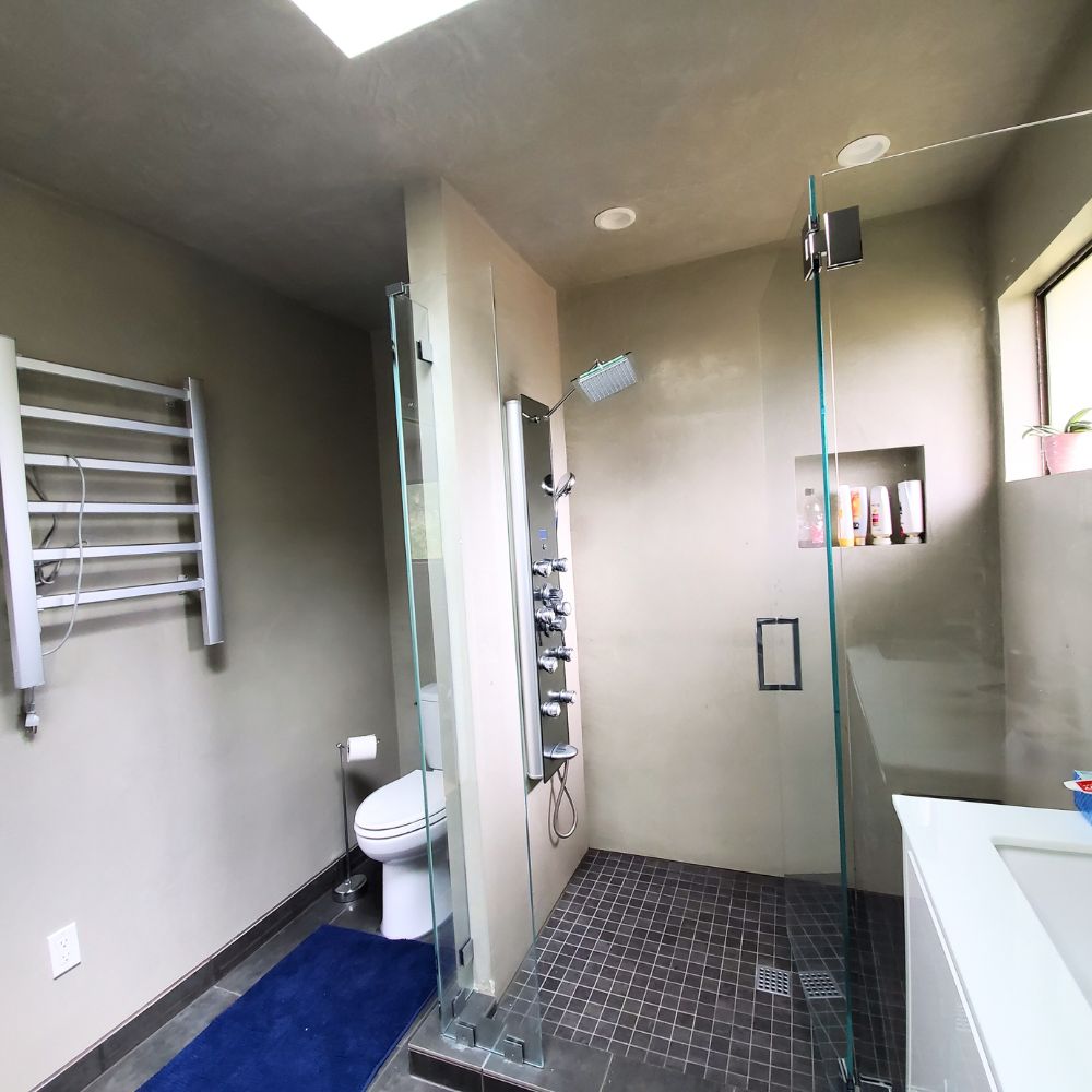 Bathroom with natural light and stylish fluorescent lights creating a welcoming atmosphere