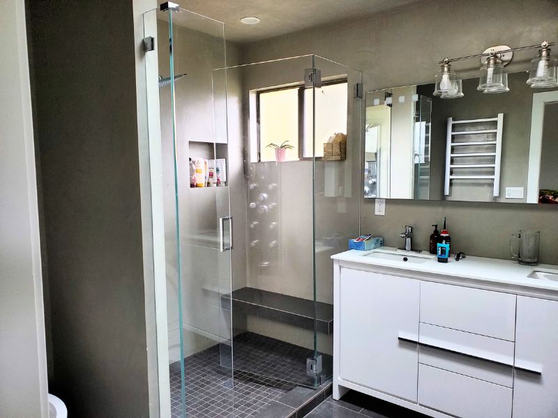 Bathroom with natural light and stylish fluorescent lights creating a welcoming atmosphere